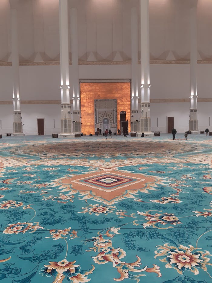 Ornate interior of the Great Mosque in Algiers showcasing stunning carpets and architecture.