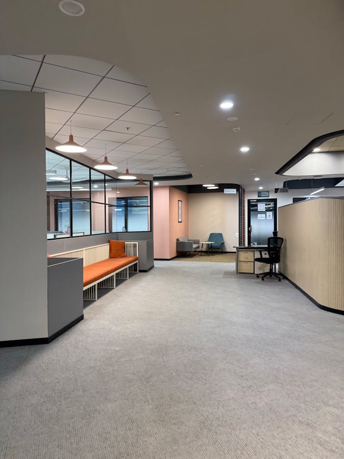 Spacious office interior with modern furnishings and neutral tones.