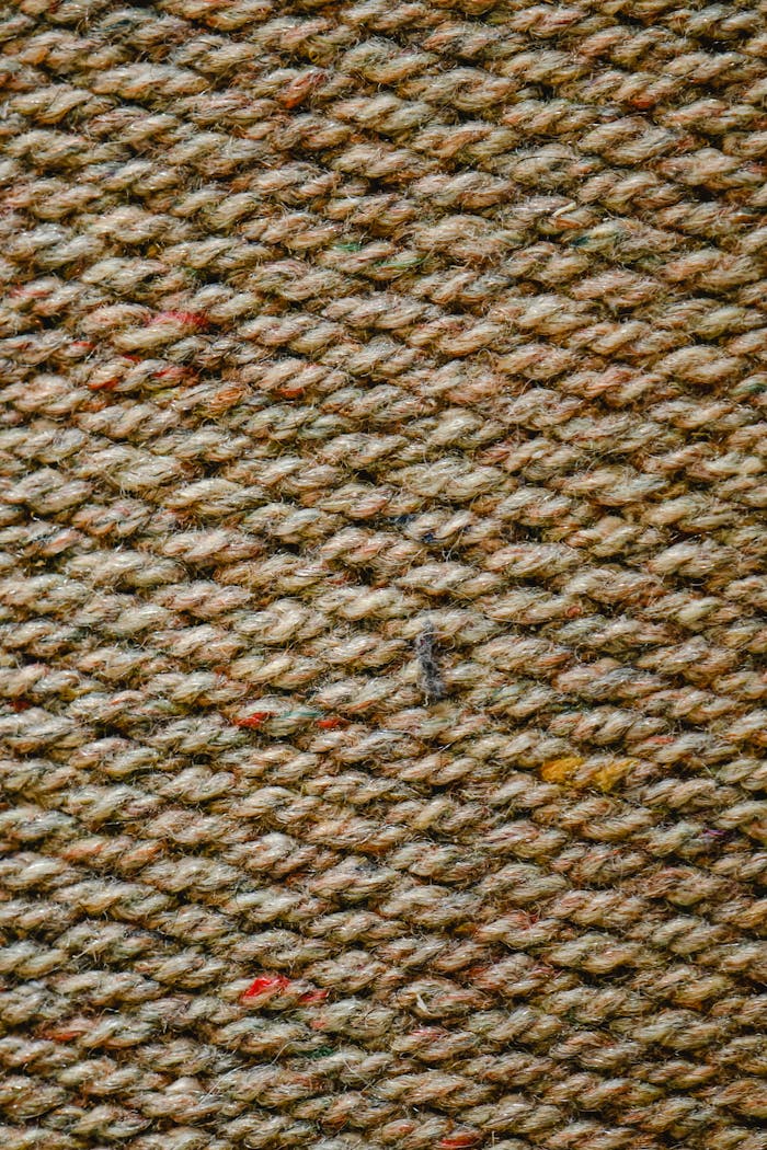 Detailed close-up of a woolen fabric weave showcasing texture and patterns.
